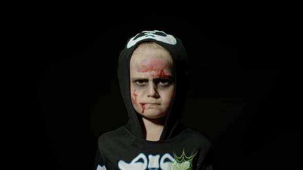 Halloween, Angry Girl with Blood Makeup on Face. Kid Dressed As Scary Skeleton, Posing, Making Faces