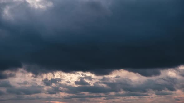 Clouds in the Sky Move Against the Background of the Sun at Sunset Timelapse