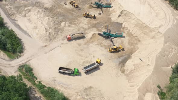 Aerial view of mining machinery working at sand quarry. Mining equipment