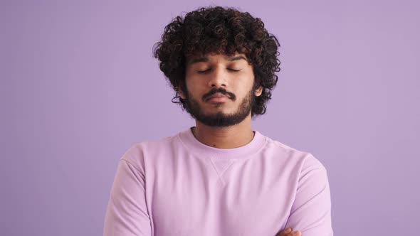 Confident curly-haired Indian man disagrees with something