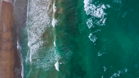 Aerial View of the Mediterranean Coast Waves Reach the Deserted Sandy Beach