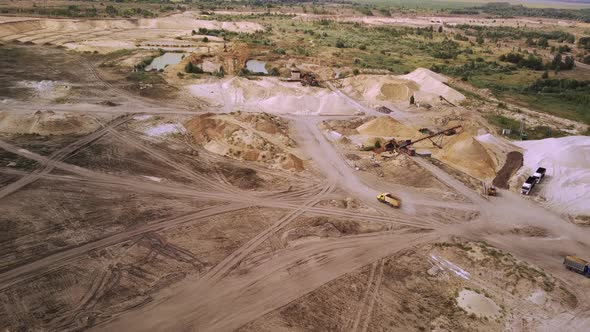 The Truck is Driving Through a Sand Quarry