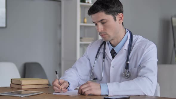 Doctor Writing Medical Treatment for Patient