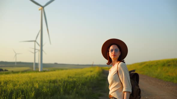 Young photographer in a hat in alternative energy park