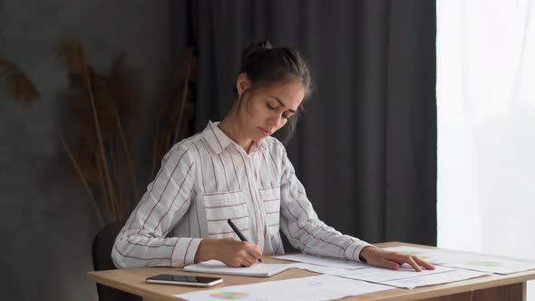 Focused Girl Writing Notes Working with Chart and Documents Study with Papers and Books Serious