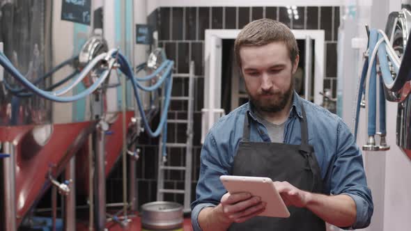 Brewery Worker With Digital Tablet At Factory