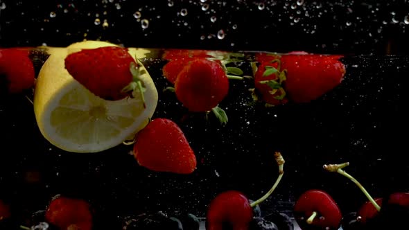 Juicy Strawberries falling in a tank full of water