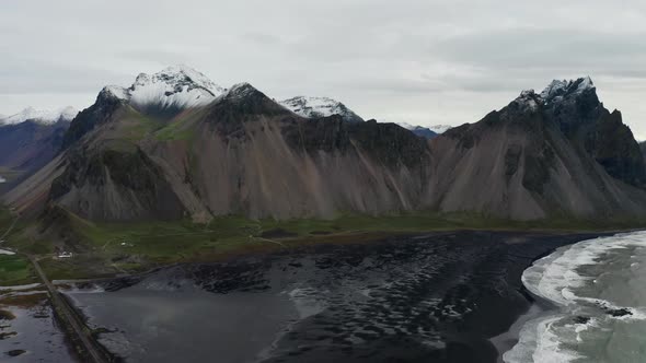 Drone Panning Over Black Sand Beach And Vestrahorn Mountain