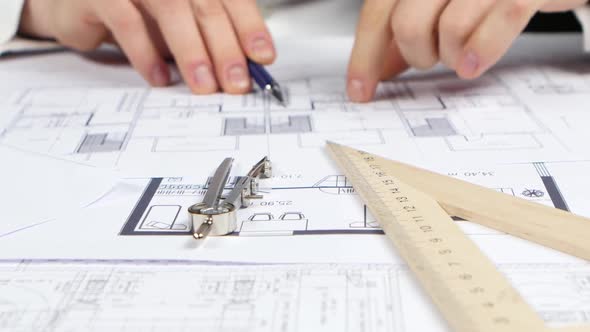 Designer Checks the Data for the Reconstruction of the Store. Close Up