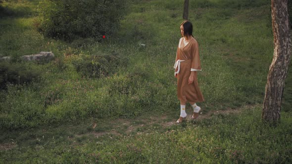 Asian Woman in Traditional Japanese Kimono Outdoors