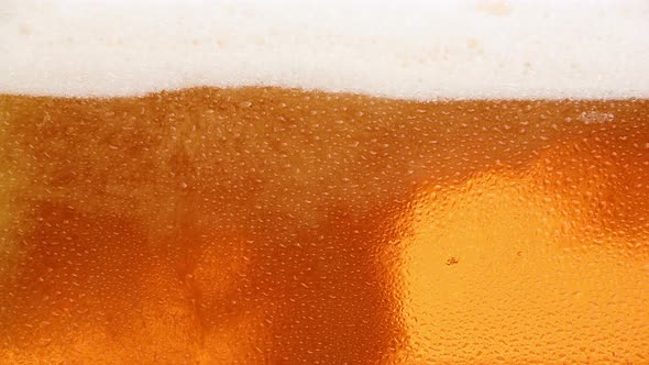 Close up background of beer with bubbles in glass