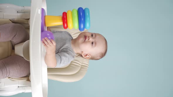 Baby15-25 months originally collects a plastic pyramid sitting on a chair.