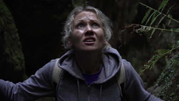 Frightened Woman in a Dark Forest. The Woman Runs Away From Danger and Gets Lost in the Forest