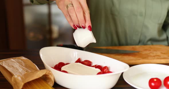 Step by step woman cooking feta cheese pasta, pours olive oil