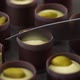 Close Up of Knife Cuts Milk Chocolate Candie with Creamy Filling and Pistachio Nuts - VideoHive Item for Sale