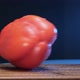 Wet Bell Pepper of Red Colour Spins on Brown Wooden Board - VideoHive Item for Sale