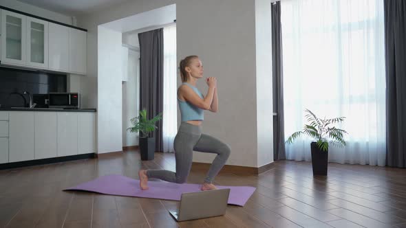 Woman Watching Fitness Video Laptop Doing Squats