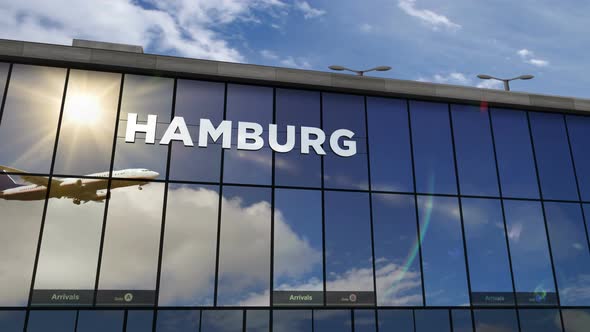 Airplane landing at Hamburg Germany airport mirrored in terminal