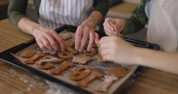 Happy Mother and Her Little Toddler Baby Boy Son Spread Cookies on a Baking Sheet