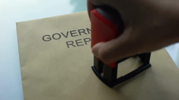 Government Report Top Secret, Stamping Seal on Folder With Important Documents