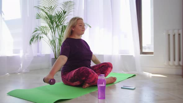 Fitness Training Blonde Overweight Woman Doing Fitness Exercises with Dumbbells Then Takes Her Phone