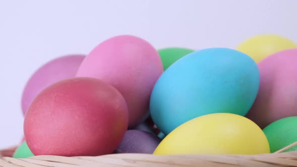 Background of Rotating Easter Colorful Chicken Eggs in Basket