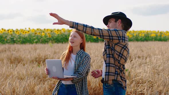 Modern Farming Couple Take the Laptop in the