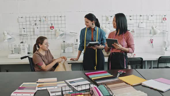 Fashion Designers Talking to Seamstress about Garment