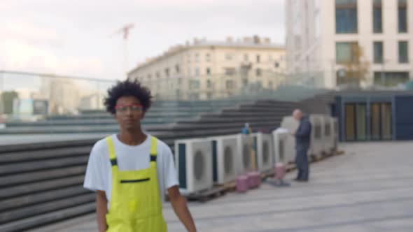 Portrait of African Man in Uniform and Safety Glasses During Air Conditioning Installation