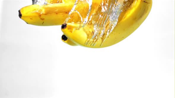 Super Slow Motion a Bunch of Bananas Falls Under the Water with Air Bubbles