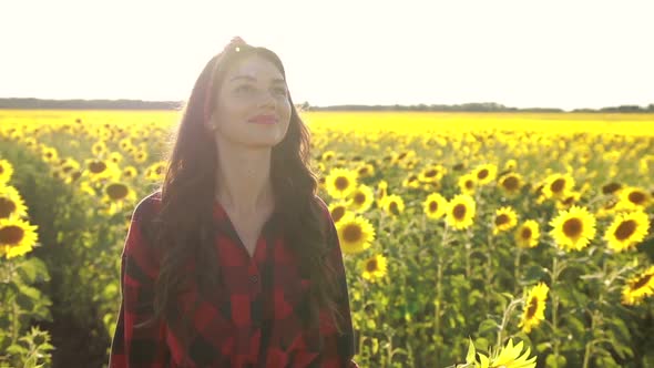 Delighted Girl Enjoying Summer in Sunflower Field