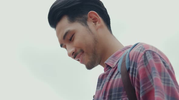 Smile portrait of handsome young Asian man solo tourists.