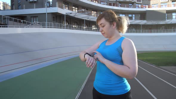 Woman Runnner Choosing Options on Fitness Bracelet