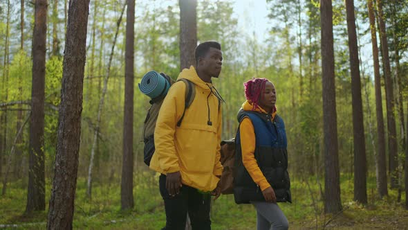 Black Couple Holdings Hands Walking Towards Lake