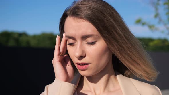 Overwhelmed Female Manager Having Headache Standing Outdoor at Sunlight