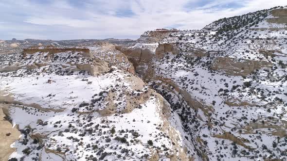 Flying over snowy canyons in the Utah desert