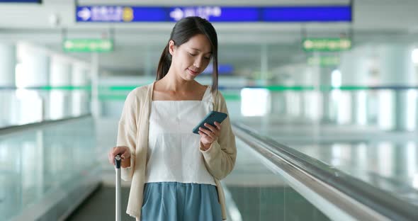 Woman use of mobile phone in the airport