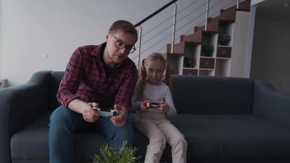 Father and Child Playing at Video Games and Spending Time Together