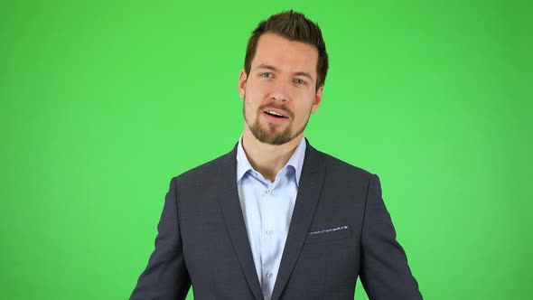 A Young Businessman Talks To the Camera, Throwing Out His Hands Helplessly - Green Screen