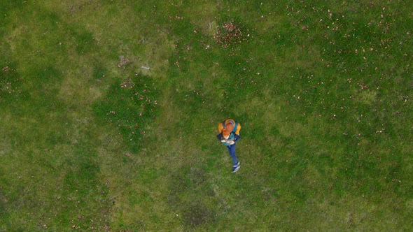 View From Above Father and Son are Having Fun on a Green Meadow in an Autumn Park