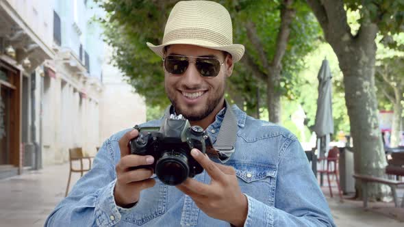 Handsome Tourist Checking Photos in Digital Camera