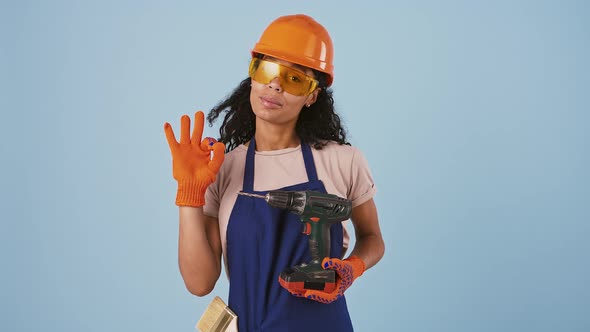 Ethnic Black Girl Worker in Hard Hat Protective Goggles and Gloves