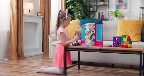 Little Girl's Play in the Living Room at Table