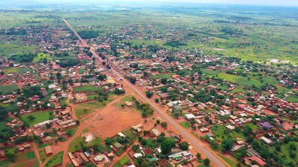 Drone flying high over an African village market.