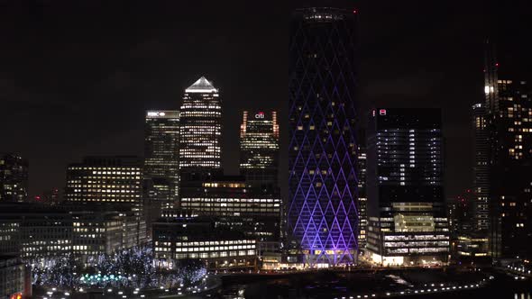 Slider drone shot of Canary wharf skyscrapers banks at night