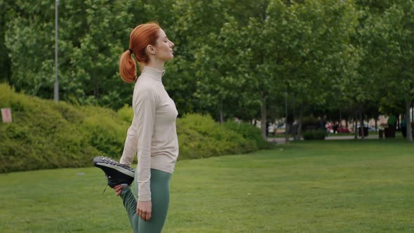 Female stretching gegs after running jog workout.