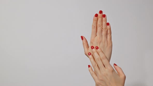 Beautiful Woman's Hands with Bright Red Manicure