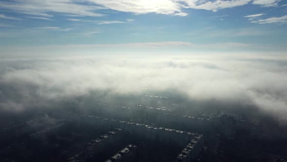 Aerial Drone View Flight Over Above Fog Mist and Roofs of Buildings in City