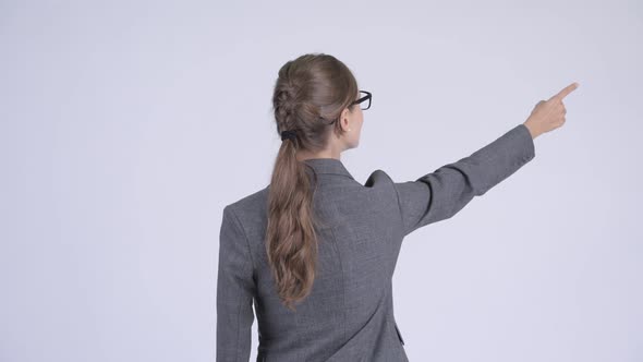 Rear View of Young Businesswoman Directing and Pointing Finger
