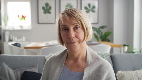 Video portrait of senior woman sitting at home. Shot with RED helium camera in 8K.